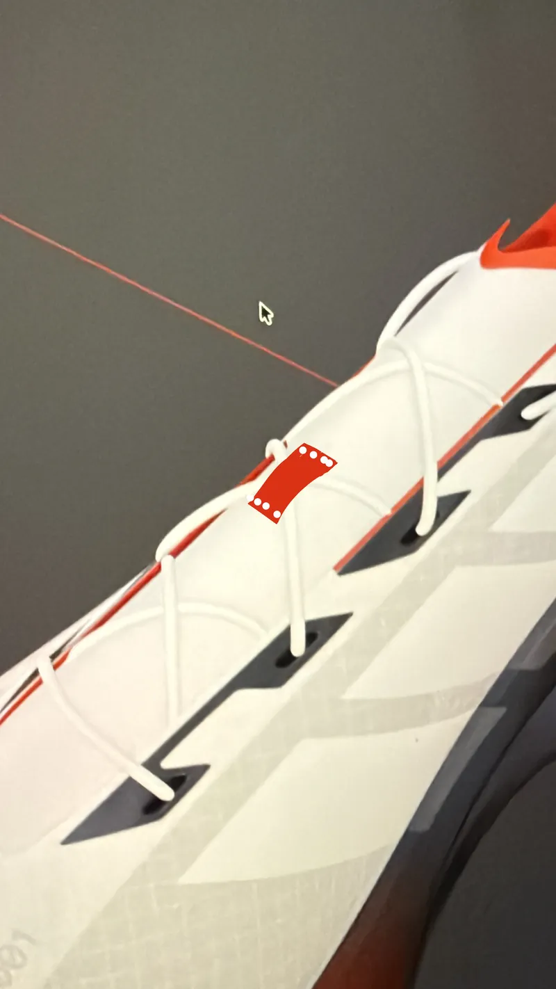Close-up of a white and red upper on screen