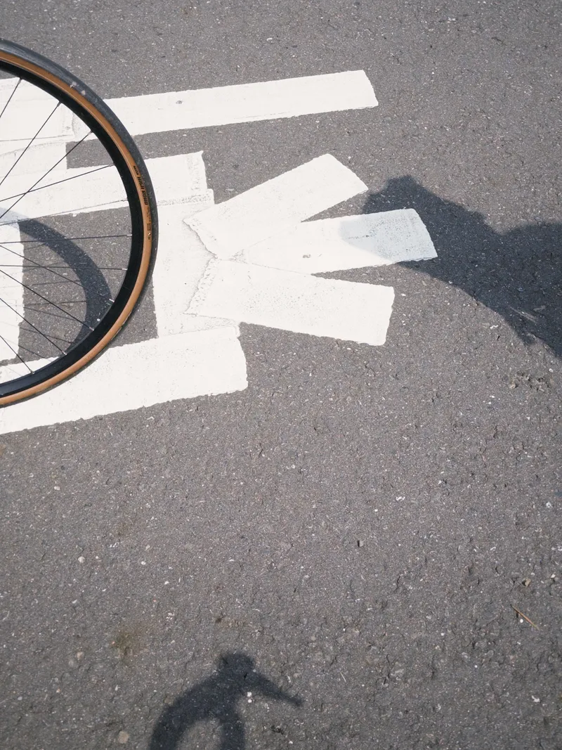 Bicycle wheel and tape on a road