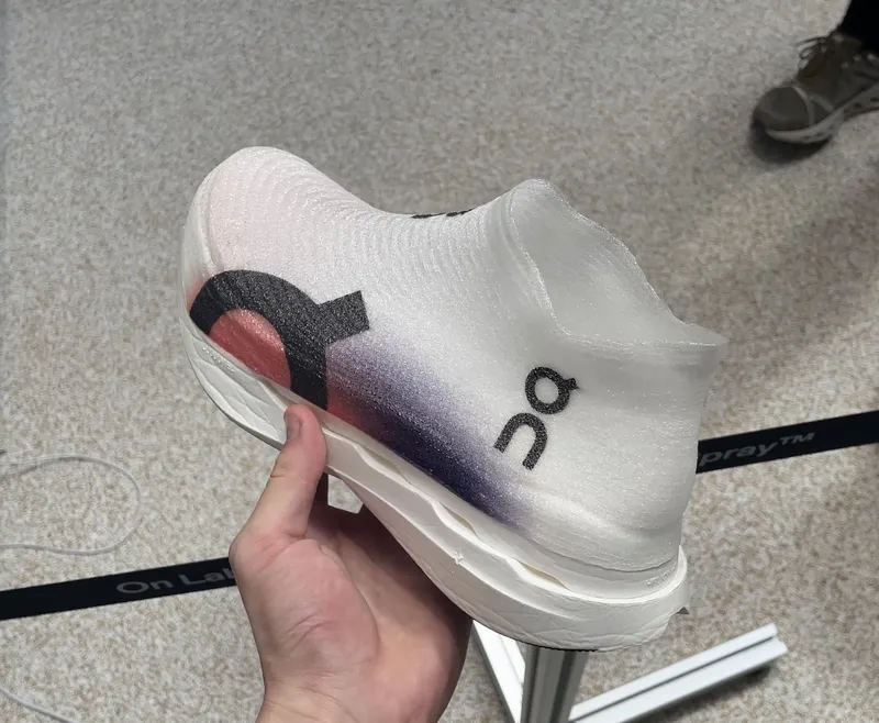 On LightSpray shoe held in hand