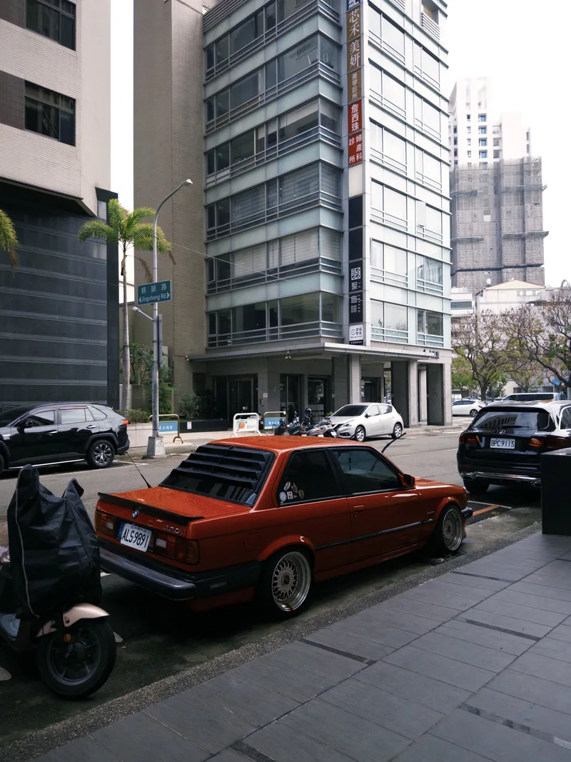 Red car parked on a city street
