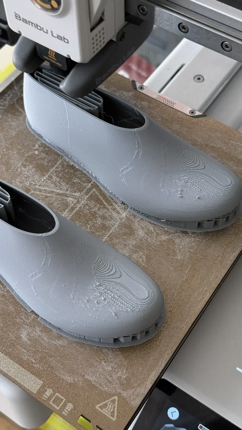 3D printed shoes on a printer bed