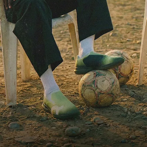 On CloudTouch visual, feet resting on a football